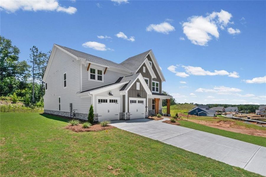 Front exterior of a new home in Woodberry, Canton, GA, highlighting curb appeal (Image 23). Front exterior of a new home in Woodberry, Canton, GA, highlighting curb appeal (Image 23).