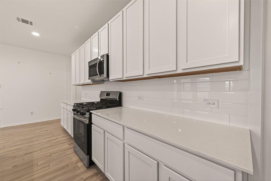 Furnished interior view inside a new home in Sunterra, Katy (Image 12).
