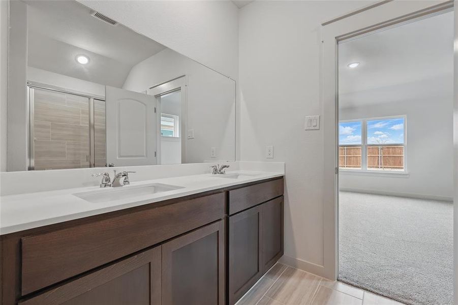 Bathroom featuring double vanity and light colored carpet Bathroom featuring double vanity and light colored carpet