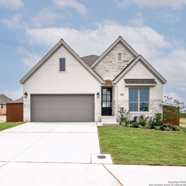 Front exterior of a new home in Homestead 55', Cibolo, TX, highlighting curb appeal (Image 23). Front exterior of a new home in Homestead 55', Cibolo, TX, highlighting curb appeal (Image 23).