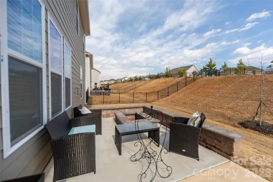 Enjoy evenings by the built-in fire pit in the private backyard.