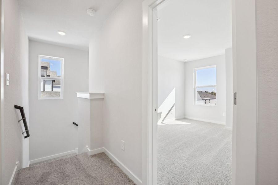 A hallway with white walls.