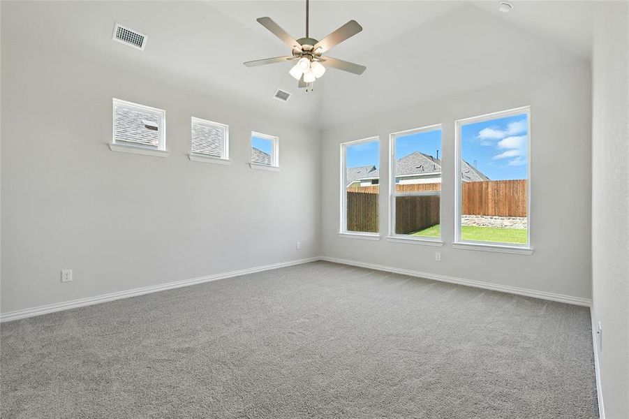 Spare room with ceiling fan, light carpet, and lofted ceiling
