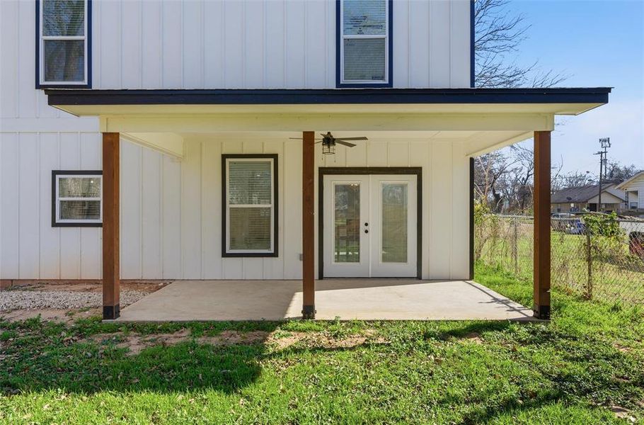Doorway to property featuring ceiling fan, board and batten siding, french doors, and a patio Doorway to property featuring ceiling fan, board and batten siding, french doors, and a patio