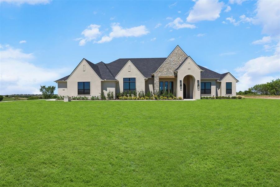 Front exterior of a new home in Bear Creek Ranch, Aledo, TX, highlighting curb appeal (Image 2). Front exterior of a new home in Bear Creek Ranch, Aledo, TX, highlighting curb appeal (Image 2).