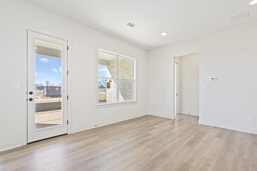 Spare room with light wood-style floors and recessed lighting