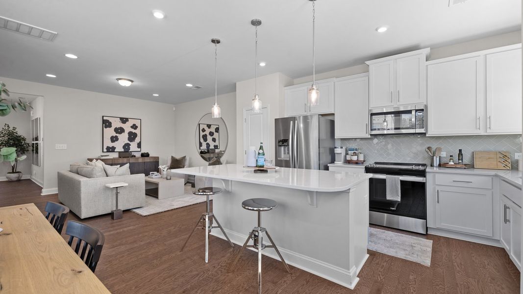 Large kitchen with premium lighting and open concept family room in the new Rochester Design by DRB Homes Charlotte, NC Large kitchen with premium lighting and open concept family room in the new Rochester Design by DRB Homes Charlotte, NC