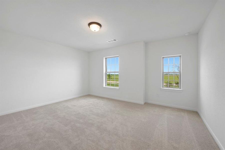 Carpeted room with white walls, two windows, and a flush-mount ceiling light