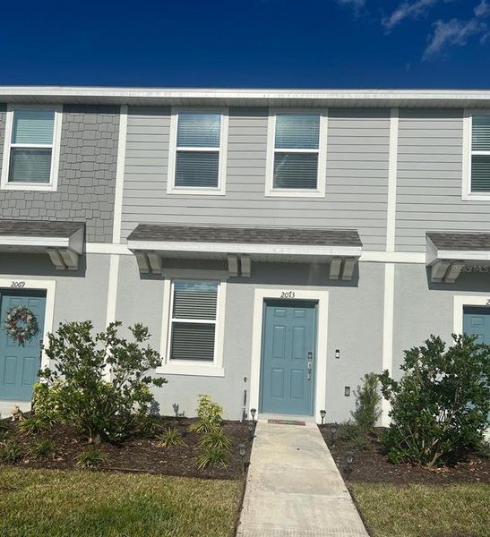 Front exterior of a new home in , Kissimmee, FL, highlighting curb appeal (Image 1). Front exterior of a new home in , Kissimmee, FL, highlighting curb appeal (Image 1).