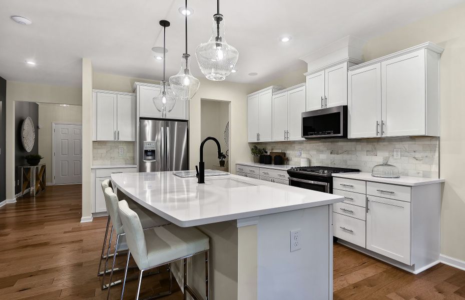 The Braddock spacious kitchen with an island is a culinary haven, boasting abundant room for meal preparation.