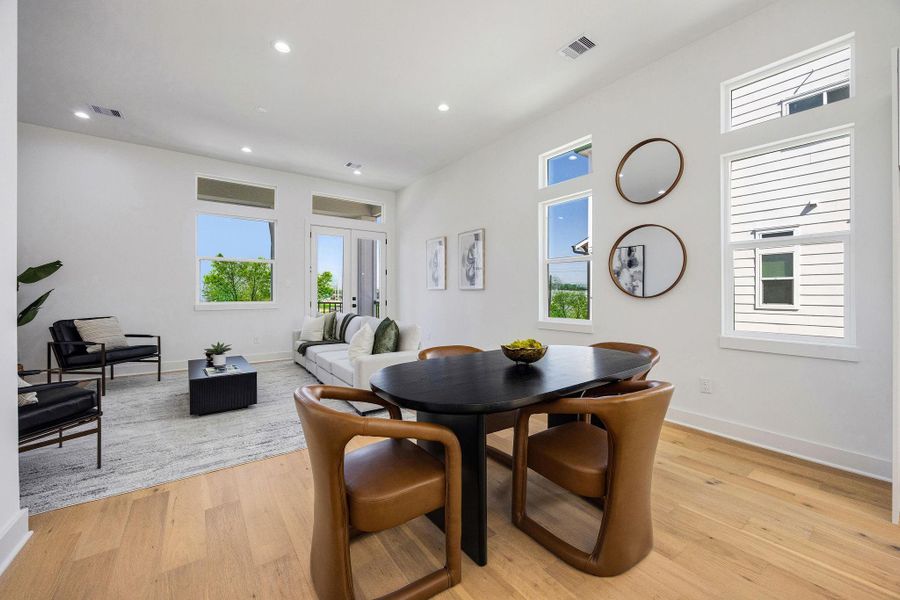 View of the dining area seamlessly connected to the living room and balcony perfect for entertaining and family gatherings.