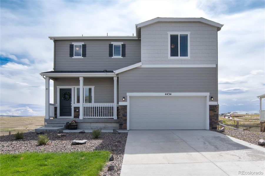 Front of home with adorable porch.