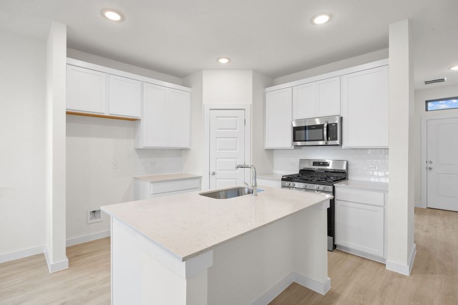 Kitchen in the Pearl home plan by Trophy Signature Homes – REPRESENTATIVE PHOTO