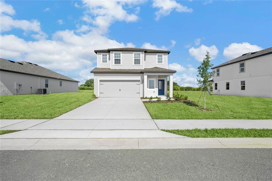 Front exterior of a new home in Citrus Place, Babson Park, FL, highlighting curb appeal (Image 2). Front exterior of a new home in Citrus Place, Babson Park, FL, highlighting curb appeal (Image 2).