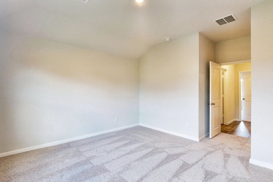 A room with a carpet and a door. A room with a carpet and a door.