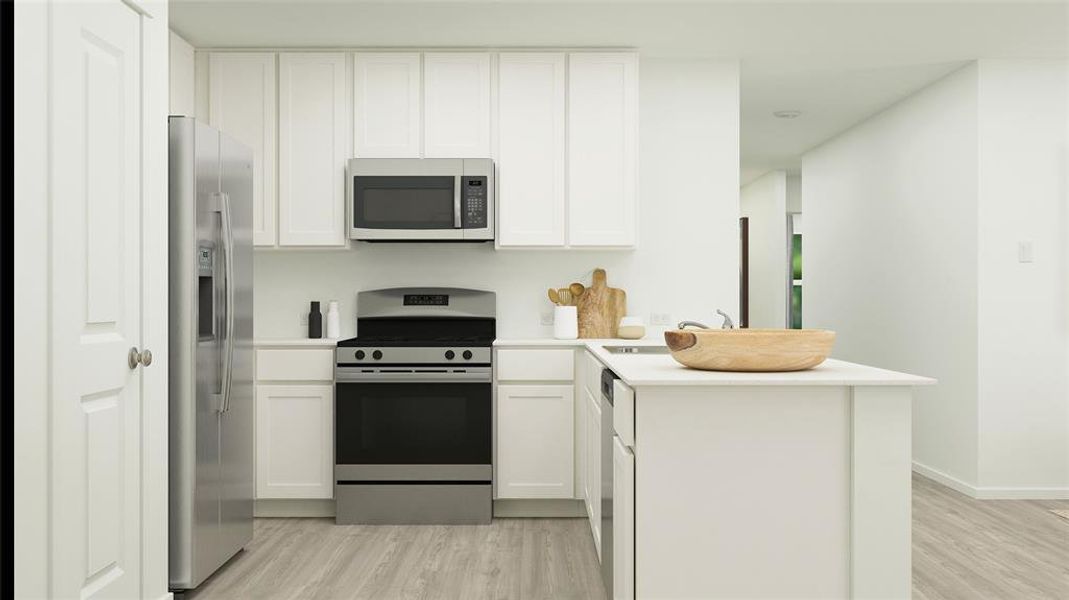 Kitchen with a peninsula, stainless steel appliances, light countertops, and light wood-type flooring