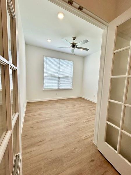 Room featuring light wood-finish flooring, recessed lighting, and a ceiling fan
