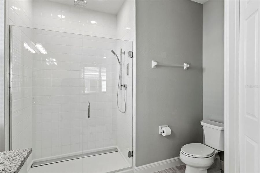 Tiled glass shower with rainfall shower head