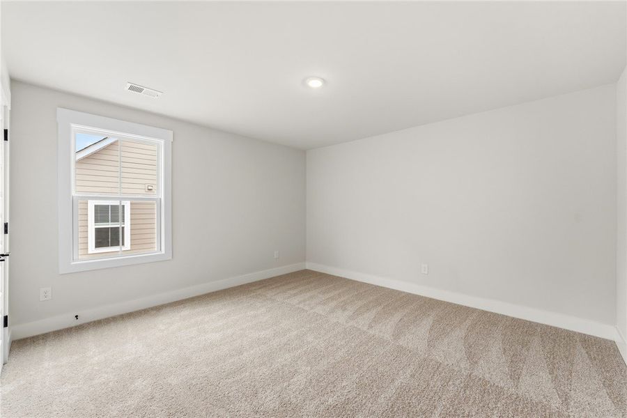 This light-filled room features plush carpeting an