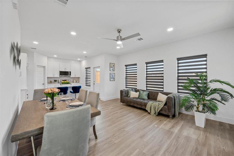 Dining room with visible vents, baseboards, a ceiling fan, light wood-style flooring, and recessed lighting