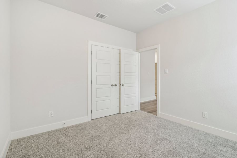 Guest bedroom in the Hughes floorplan at a Meritage Homes community.