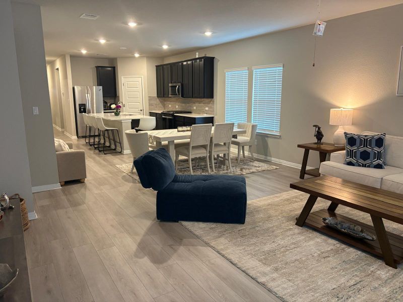 An open-concept living space integrates kitchen, dining, and relaxation zones for effortless entertaining.