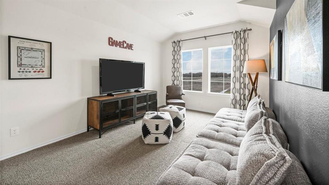Living room with carpet and vaulted ceiling