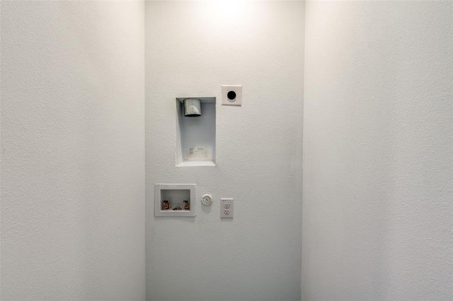 Clothes washing area with gas dryer hookup, washer hookup, and hookup for an electric dryer