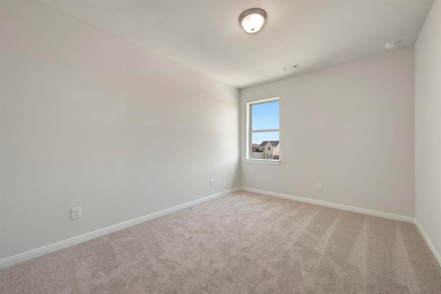 Spare room with baseboards and light colored carpet