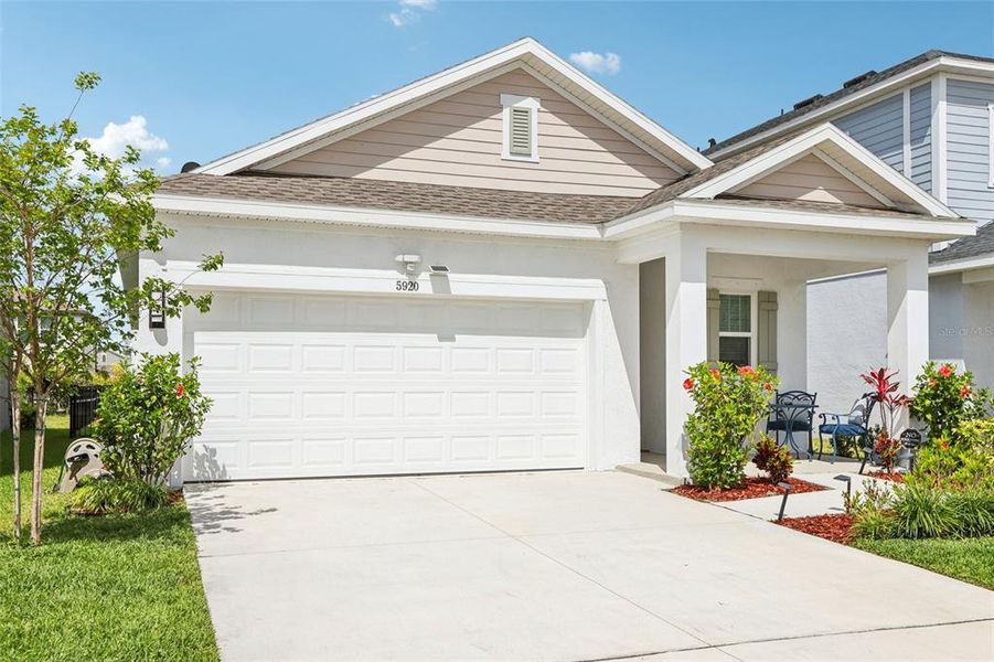 Front exterior of a new home in Waterset Garden Series, Apollo Beach, FL, highlighting curb appeal (Image 25).