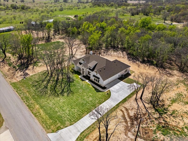 Front exterior of a new home in Spring Valley Ranch, Paradise, TX, highlighting curb appeal (Image 28).