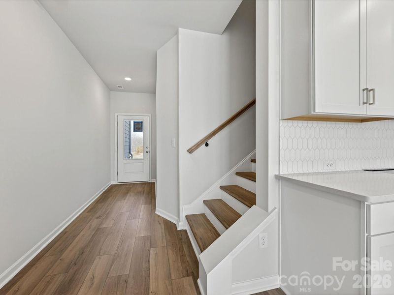 Foyer with LVP flooring and LVP composite stair treads