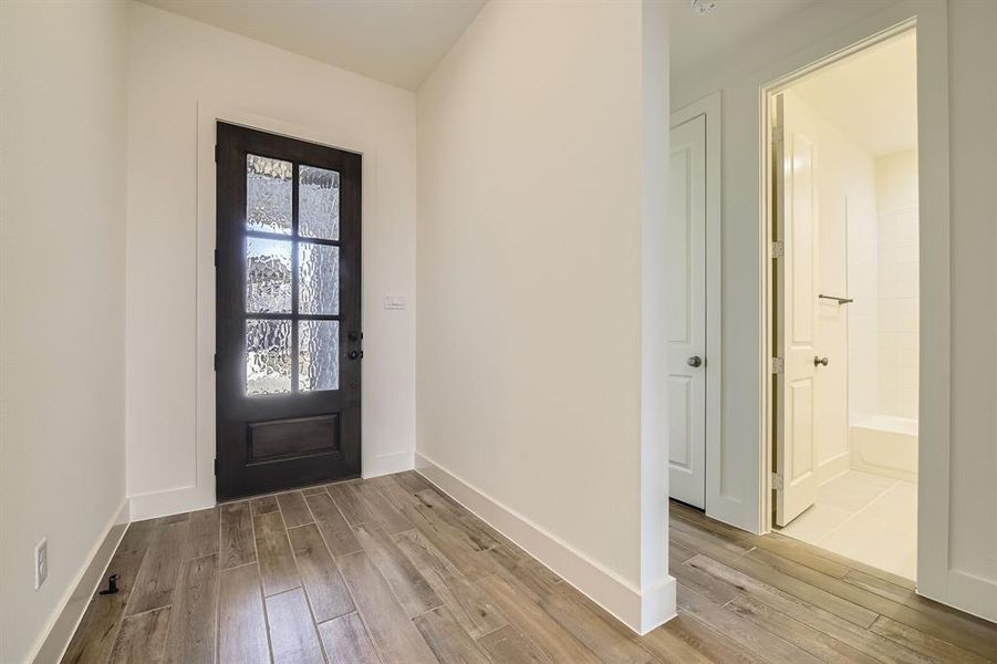 Entryway featuring baseboards and wood finished floors