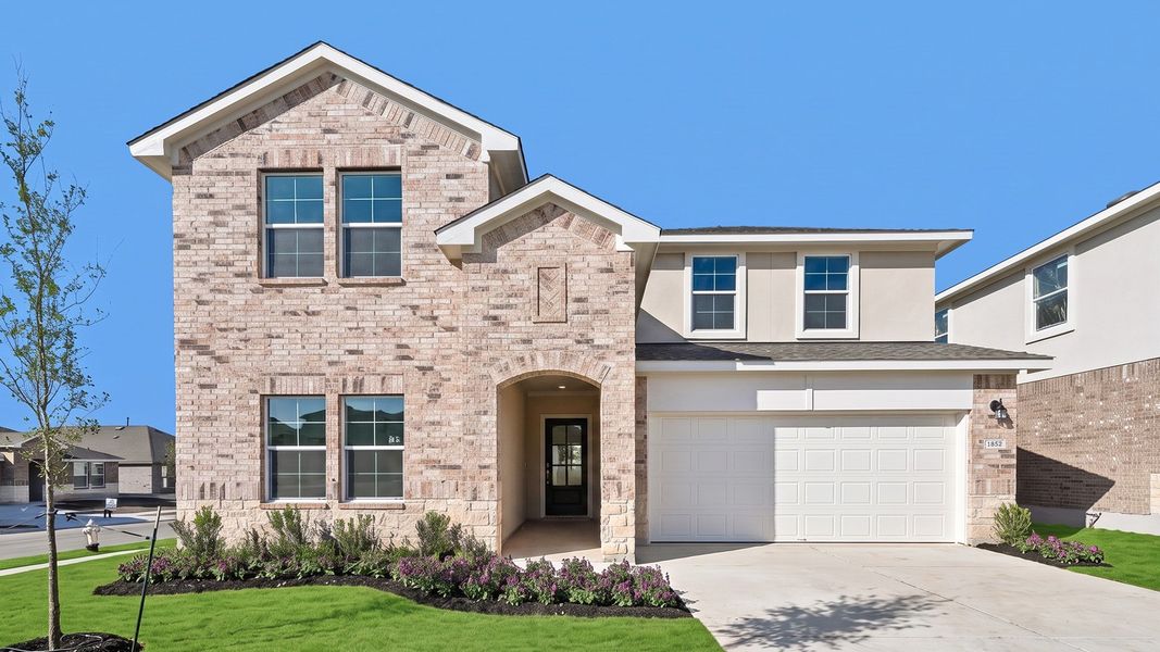 Front exterior of a new home in Bar W Ranch, Leander, TX, highlighting curb appeal (Image 1). Front exterior of a new home in Bar W Ranch, Leander, TX, highlighting curb appeal (Image 1).