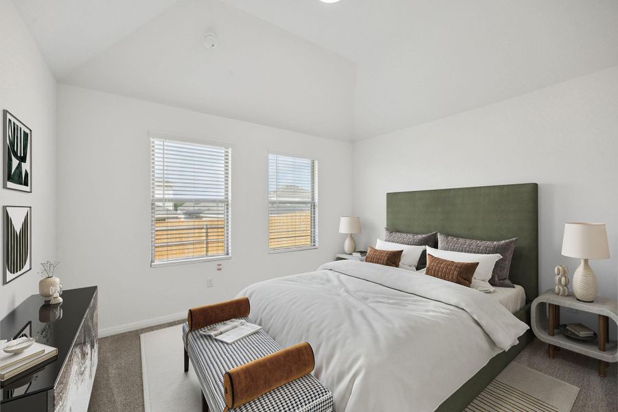 Bedroom featuring carpet and vaulted ceiling