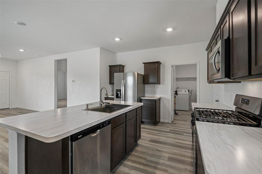 Open kitchen with ample storage adjacent to the utility room. Open kitchen with ample storage adjacent to the utility room.