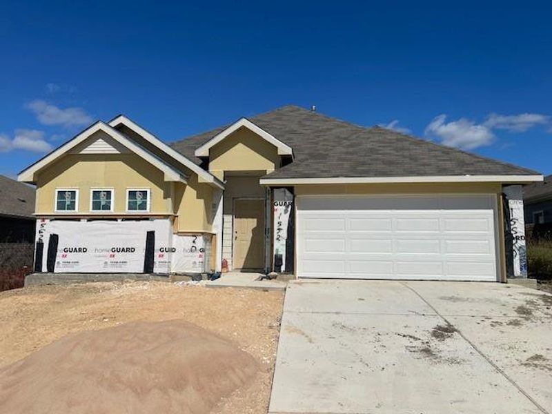 View of front of home with concrete driveway and stucco siding