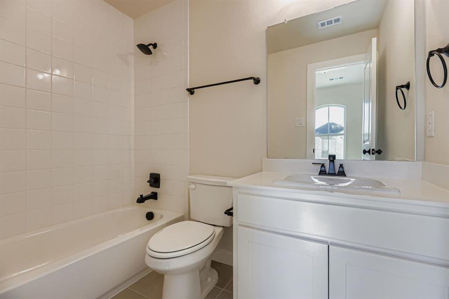 Full bathroom featuring vanity,  shower combination, and tile patterned floors
