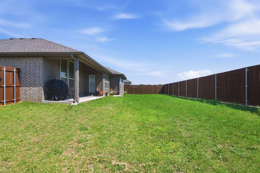 Large backyard with covered patio