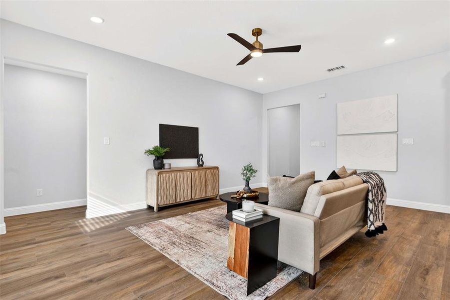 Living area with wood finished floors, a ceiling fan, and recessed lighting