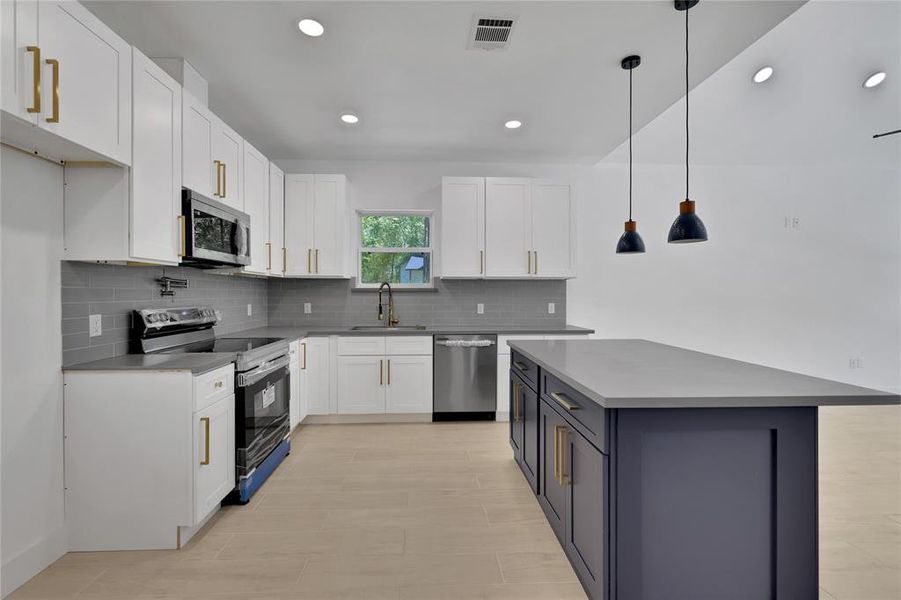 The kitchen has soft close cabinets/drawers with sleek gold hardware