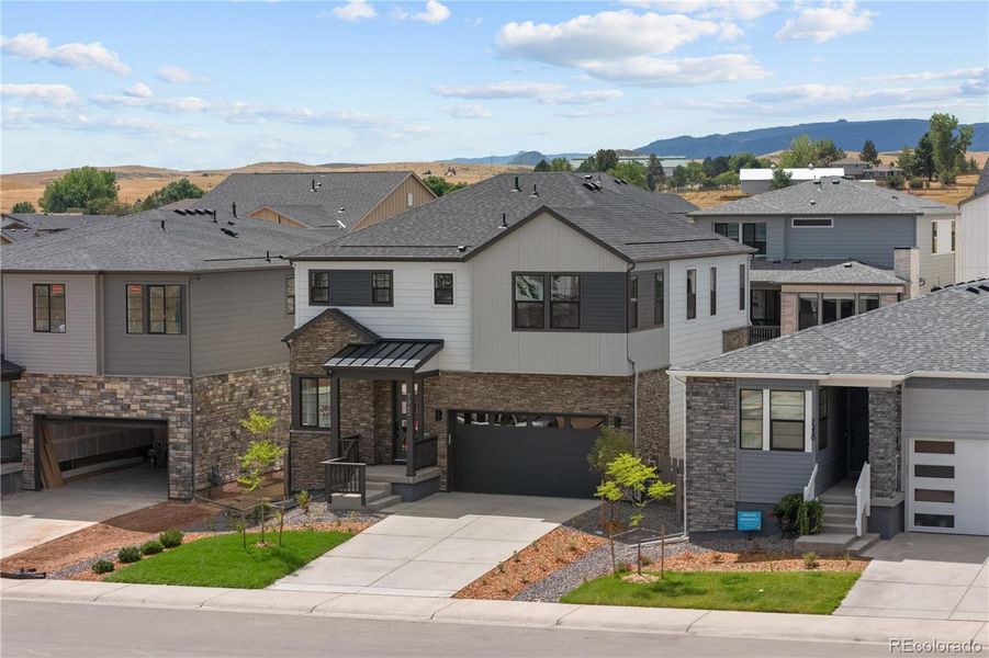 Front exterior of a new home in Harmony at Sterling Ranch, Littleton, CO, highlighting curb appeal (Image 26). Front exterior of a new home in Harmony at Sterling Ranch, Littleton, CO, highlighting curb appeal (Image 26).
