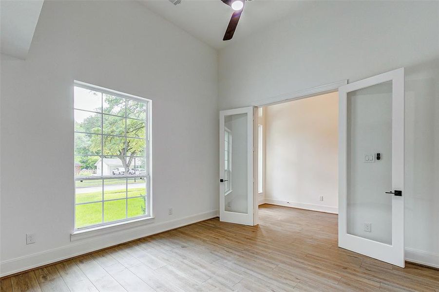 Enclosed by French doors, this marvelous study will easily accommodate your large office furniture. Features include hardwood floors, designer paint, upgraded baseboards, a tall ceiling, and a modern ceiling fan.