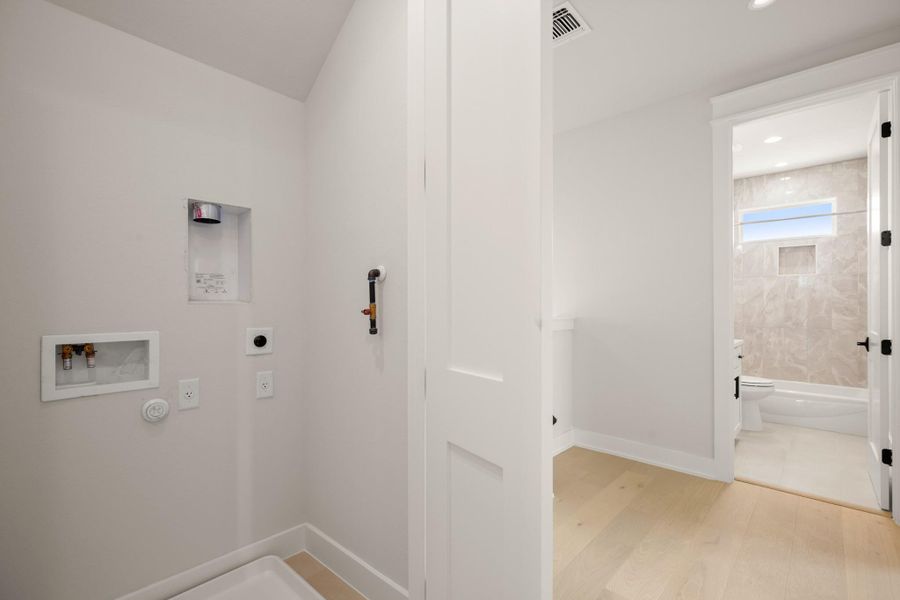 Washroom featuring light wood-type flooring, washer hookup, electric dryer hookup, recessed lighting, and gas dryer hookup Washroom featuring light wood-type flooring, washer hookup, electric dryer hookup, recessed lighting, and gas dryer hookup