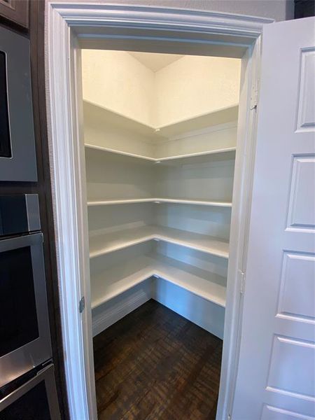 Walk-in corner pantry with lots of storage space