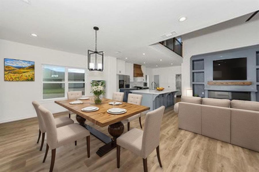 Dining space with light wood finished floors, a chandelier, and recessed lighting Dining space with light wood finished floors, a chandelier, and recessed lighting