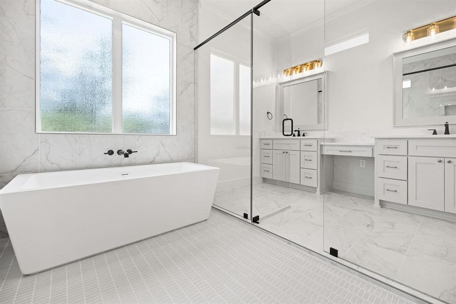 Bathroom with a freestanding bath, a shower stall, marble finish floor, and vanity