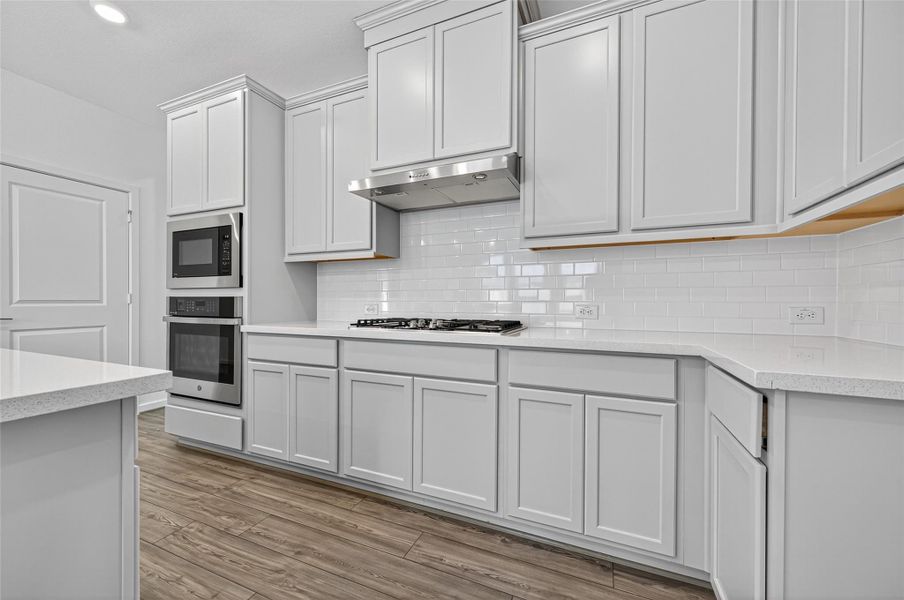 The kitchen is equipped with sleek stainless steel appliances, adding both style and durability for all your cooking needs.