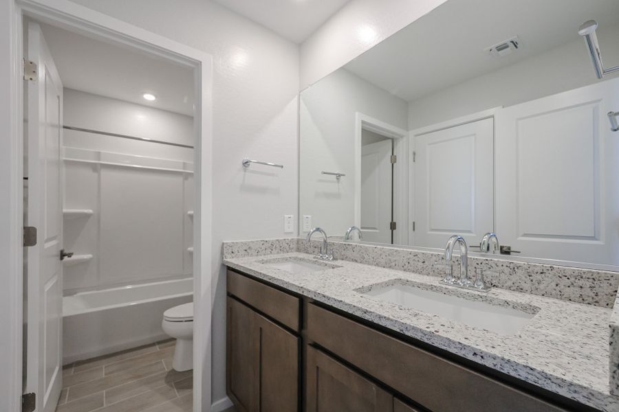 A bathroom with a marble countertop.