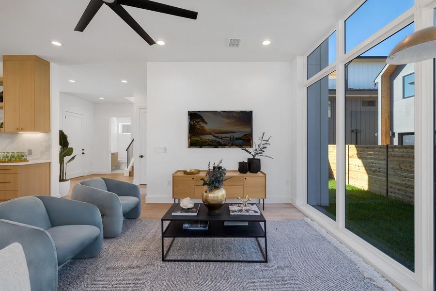Living area featuring recessed lighting, light wood-style flooring, and ceiling fan Living area featuring recessed lighting, light wood-style flooring, and ceiling fan